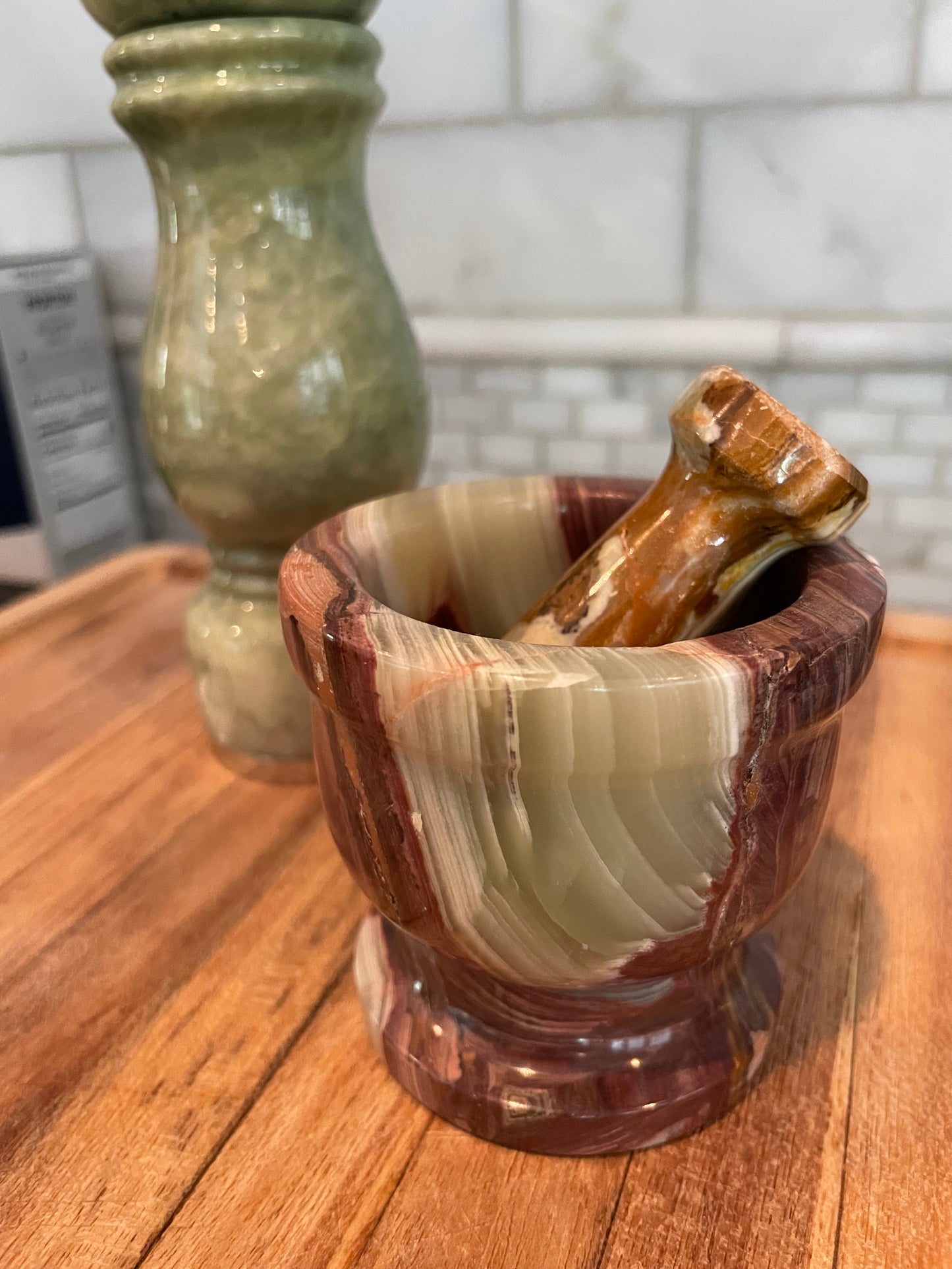 small brown and green onyx mortar and pestle